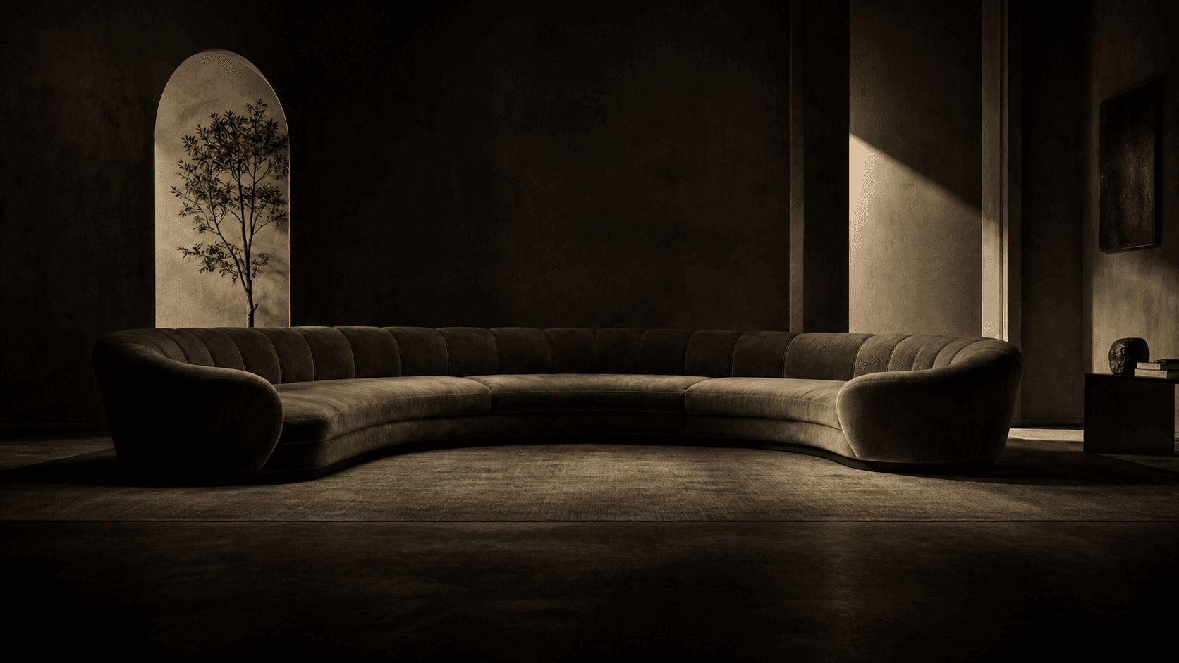 Olive velvet curved sectional in a dark gallery interior