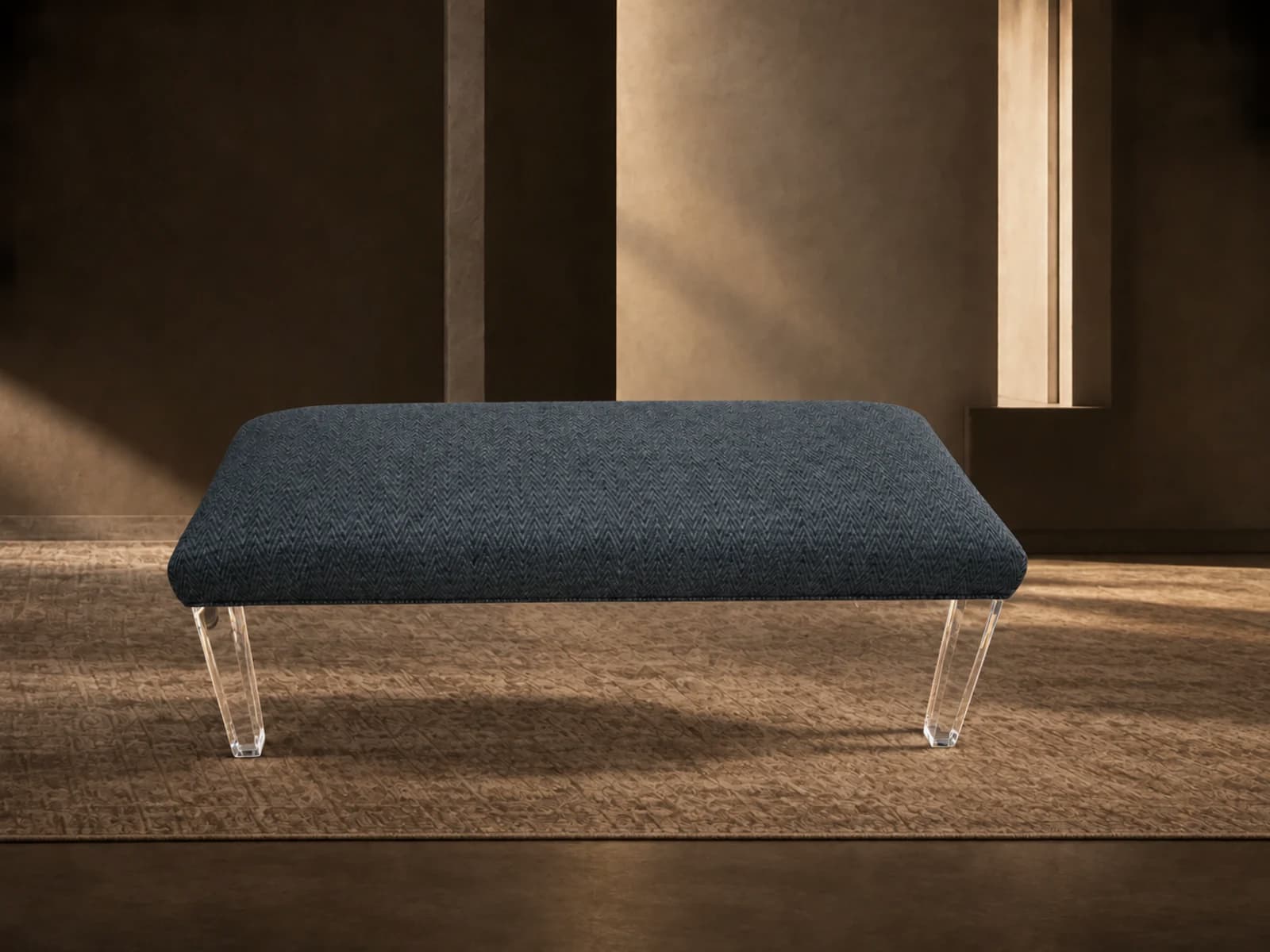 Bench upholstered in blue herringbone on clear acrylic legs